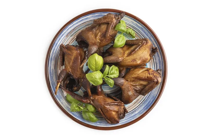 Framed Print : Smoked quails on a ceramic plate isolated on white background