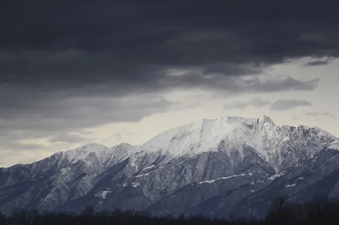 Framed Print : Snow-capped mountain with dark clouds