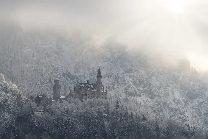 Framed Print : Snow-covered castle against an alpine backdrop