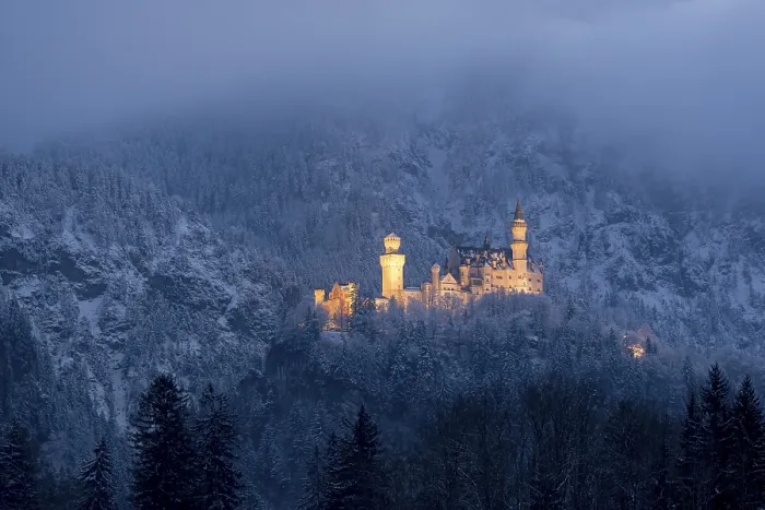 Framed Print : Snow-covered castle, illuminated at dusk