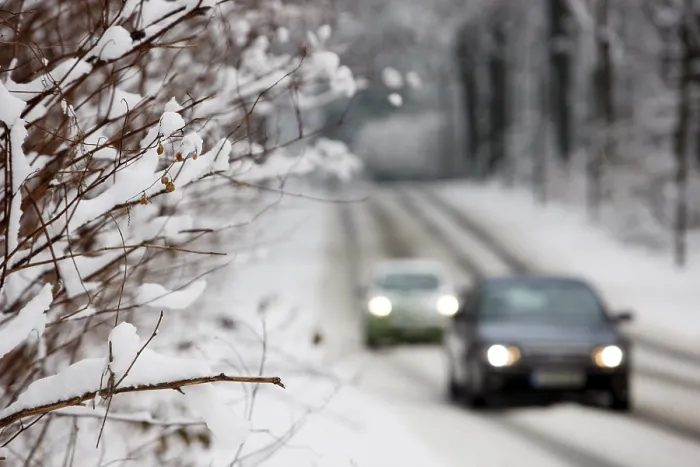 Framed Print : Snow-covered country road in a forest