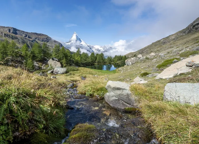Framed Print : Snow-covered Matterhorn, mountain stream flows into Lake Grindij