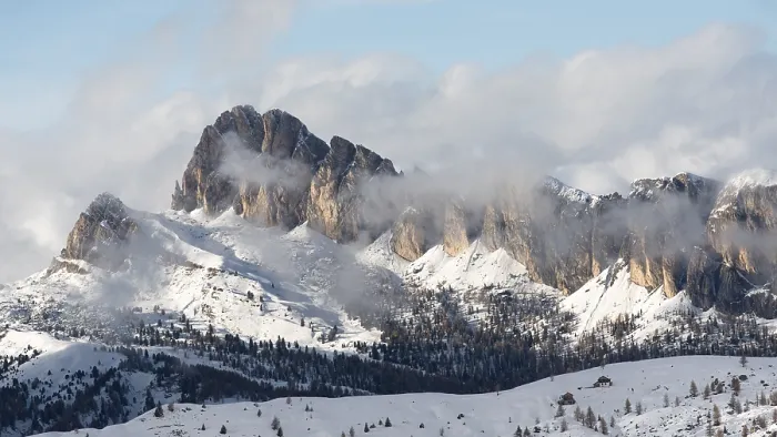 Framed Print : Snow-covered mountain peaks with clouds rolling over in a serene winter landscape
