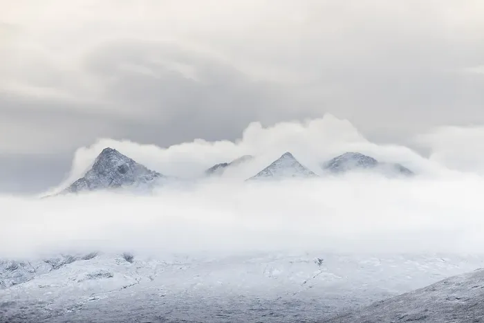 Framed Print : Snow-covered mountain peaks of the Cullins Group with clouds in snow-covered landscape Framed Print : Snow-covered mountain peaks of the Cullins Group with clouds in snow-covered landscape