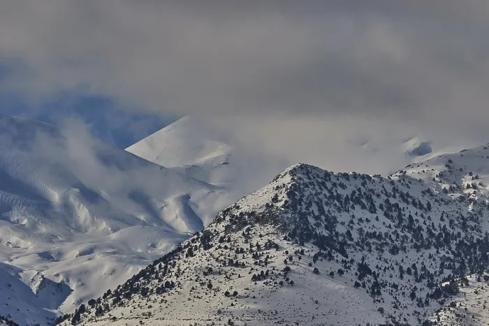 Framed Print : Snow-covered mountain range under a cloudy sky