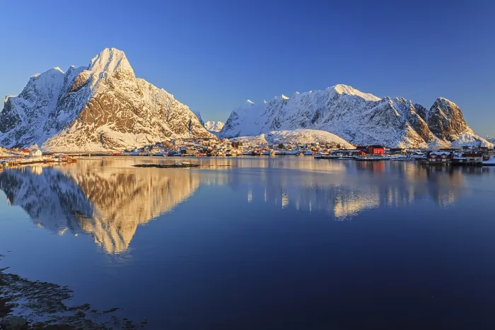 Framed Print : Snow-covered mountains reflected in fjord at sunrise