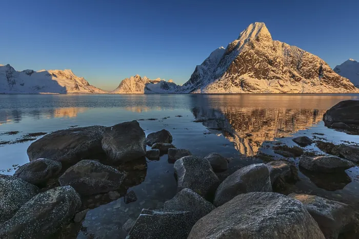 Framed Print : Snow-covered mountains reflected in the fjord at sunrise