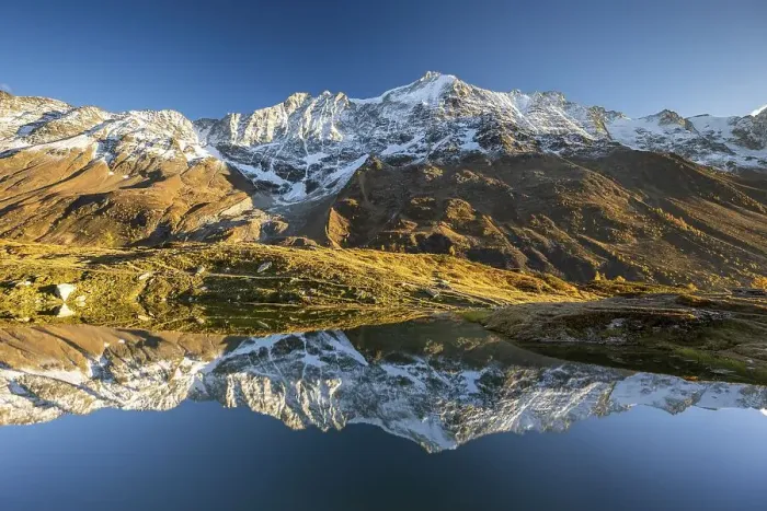 Framed Print : Snow-covered mountains reflected in mountain lake