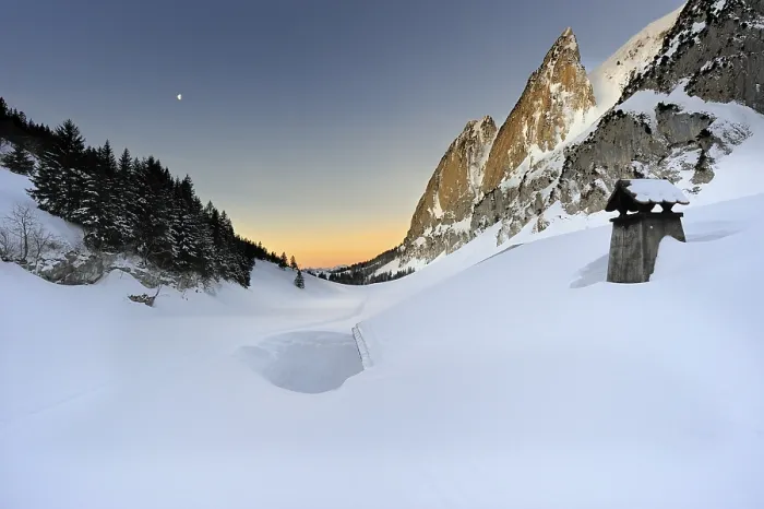 Framed Print : Snow-covered roof of a hut at sunrise