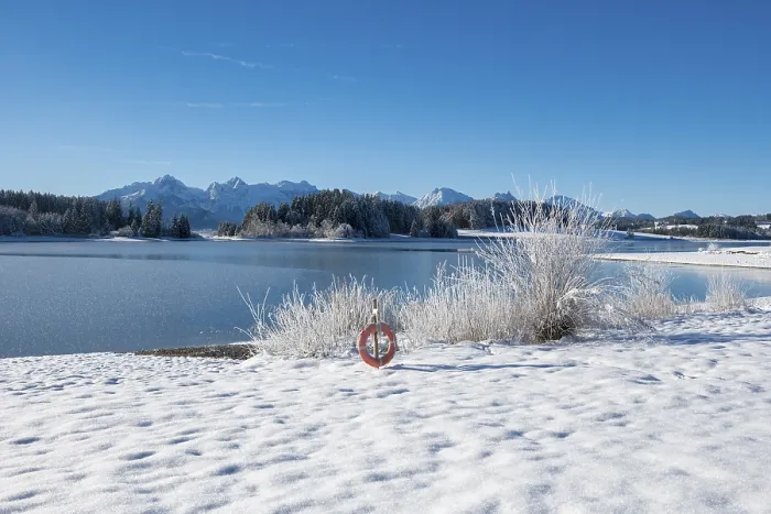Framed Print : Snow-covered shore with view of snowy mountains through clear sky Framed Print : Snow-covered shore with view of snowy mountains through clear sky