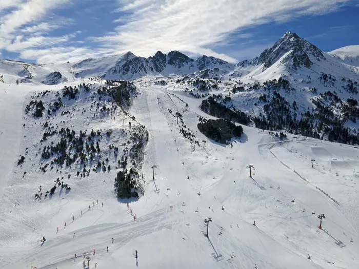 Framed Print : Snow-covered slopes with skiers and lifts in the sunny mountain area