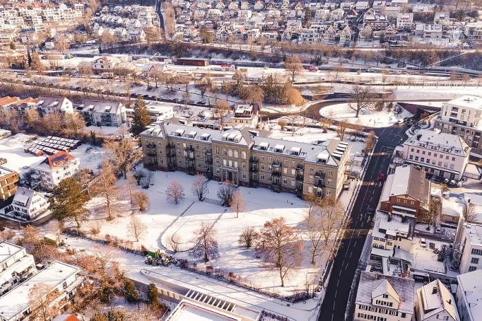Framed Print : Snow-covered town with large buildings and a main road