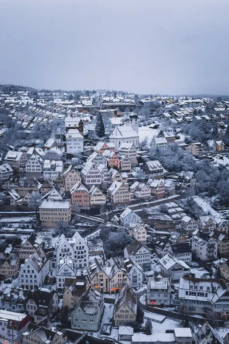 Framed Print : Snow-covered town with numerous half-timbered houses and a distinctive church