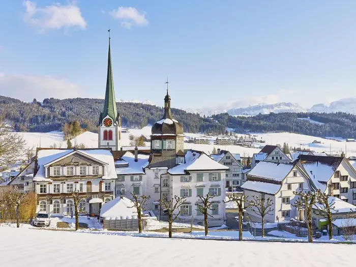 Framed Print : Snow-covered village view with typical Appenzell houses facing south with the Reformed church in the back