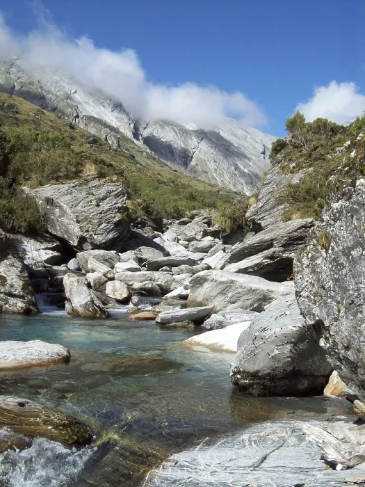 Framed Print : Snow-fed stream runs through the alpine peaks of the Southern Alps