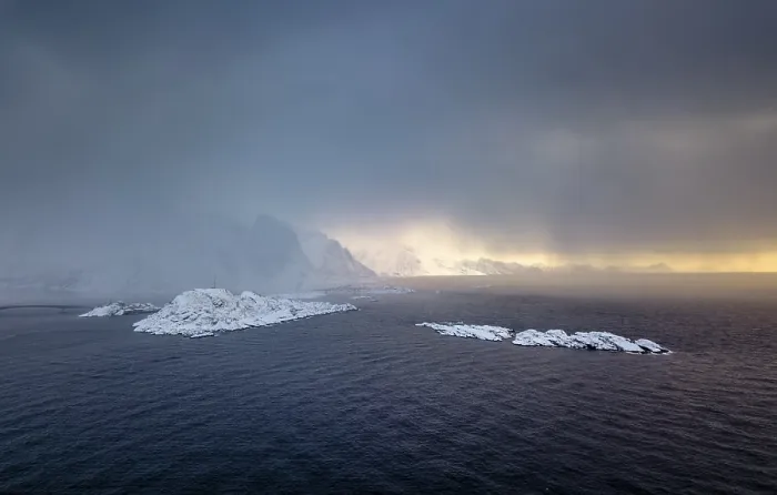 Framed Print : Snowfall over the sea and mountains