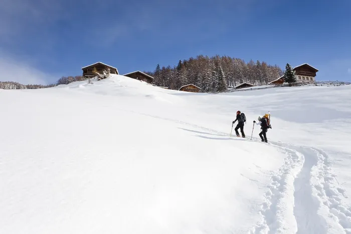Framed Print : Snowshoe hikers climbing the Morgenrast summit from Unterreinswald