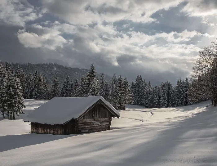 Framed Print : Snowy cabin in a wintry forest under a dramatic sky Framed Print : Snowy cabin in a wintry forest under a dramatic sky