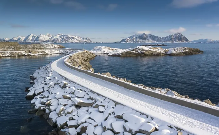 Framed Print : Snowy jetty in the sea, mountains in the back