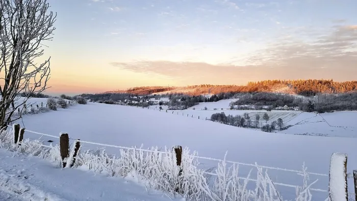 Framed Print : Snowy landscape at sunrise with hills and trees