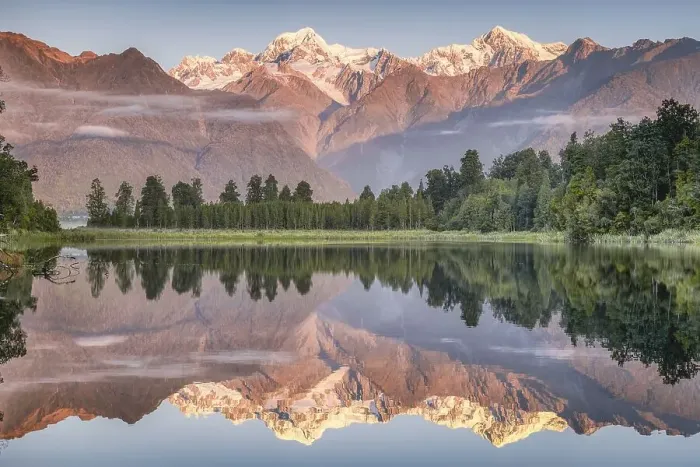 Framed Print : Snowy mountain peaks of Mount Cook and Mount Tasman reflected in Lake Matheson in the evening light