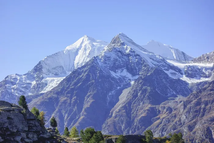 Framed Print : Snowy mountain peaks with rocks and clear sky