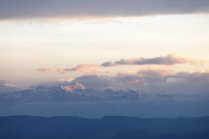 Framed Print : Snowy mountains and clouds at a gentle dusk or dawn