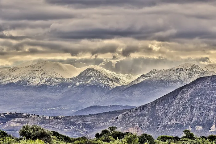 Framed Print : Snowy mountains under threatening grey clouds in a vast landscape with a dramatic atmosphere Framed Print : Snowy mountains under threatening grey clouds in a vast landscape with a dramatic atmosphere