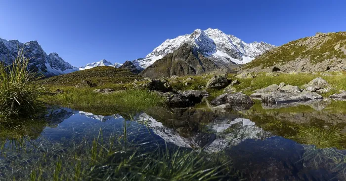 Framed Print : Snowy summit of the Hohe Seeblaskogel with reflection in a small lake