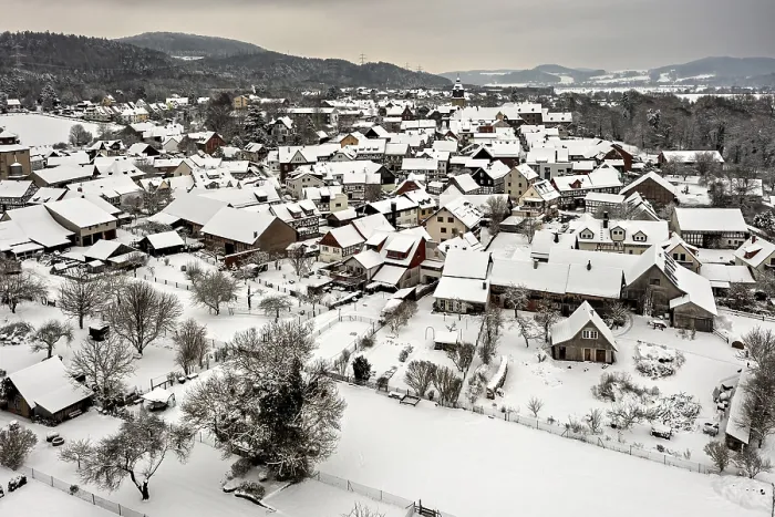 Framed Print : Snowy village with characteristic half-timbered houses under grey skies