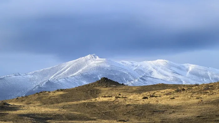 Framed Print : Solitary snow-covered mountains with a tranquil sky bathed in golden light