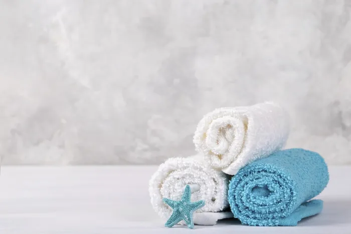 Framed Print : Spa composition with white and blue soft rolled cotton towels and star fish copy space Framed Print : Spa composition with white and blue soft rolled cotton towels and star fish copy space