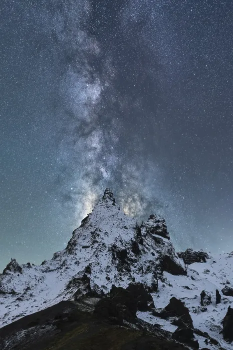 Framed Print : A spectacular view of the Milky Way illuminating the night sky over snow-covered peaks in Iceland