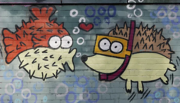 Framed Print : Spiny fish figure kissing a hedgehog figure wearing goggles