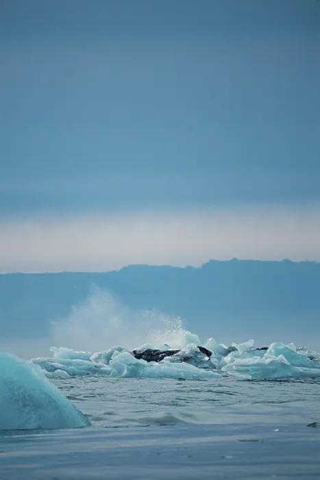 Framed Print : Splashes among icebergs in a dynamic ocean scene under a cold sky