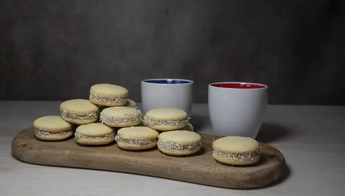 Framed Print : A stack of tasty alfajores cookies with coconut filling displayed on a wooden board