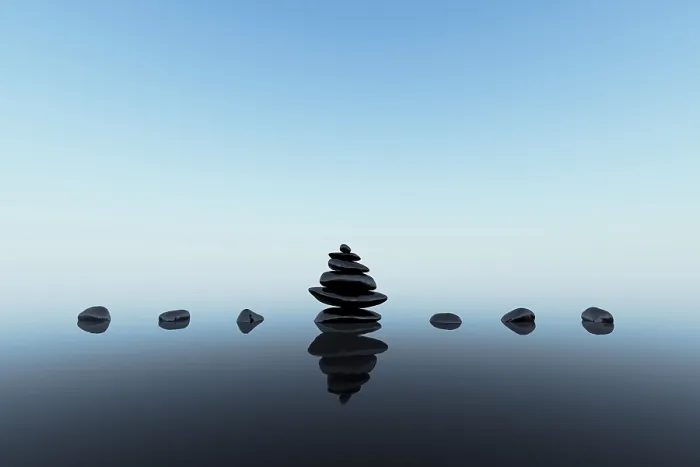 Framed Print : Stacked black stones with reflections on blue clean background