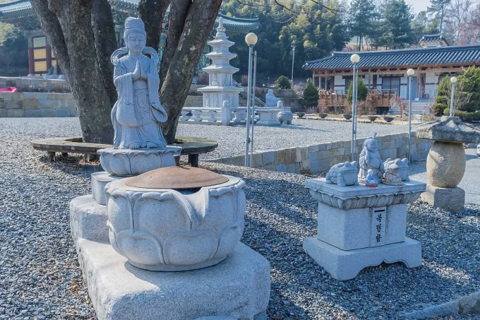 Framed Print : Standing Buddha in prayer and water cistern in front of tree at Sudosa Temple in Pyeongtaek Framed Print : Standing Buddha in prayer and water cistern in front of tree at Sudosa Temple in Pyeongtaek