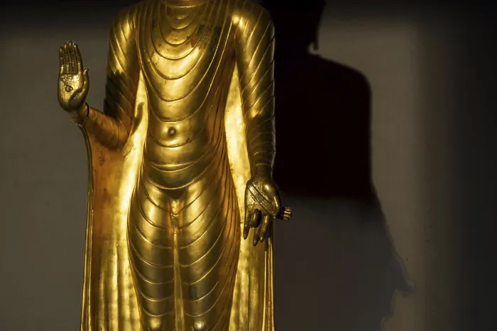 Framed Print : Standing gilded Buddha statue, the right hand (raised)