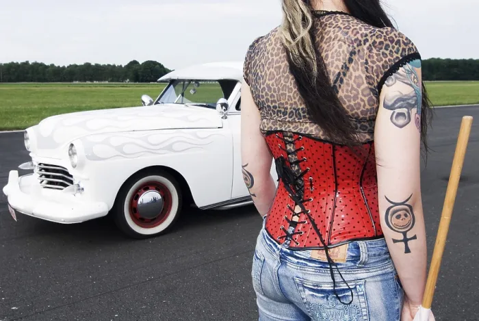Framed Print : Starter girl with a red corsage and tattoos next to a white limousine