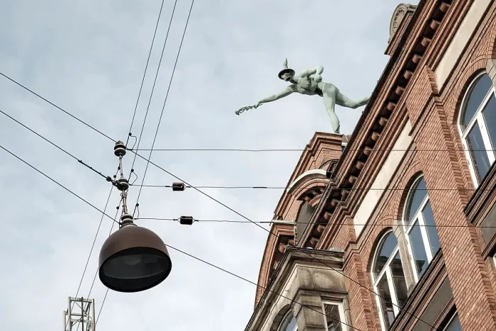 Framed Print : A statue atop a historic building against a backdrop of a clear sky with suspended cables Framed Print : A statue atop a historic building against a backdrop of a clear sky with suspended cables