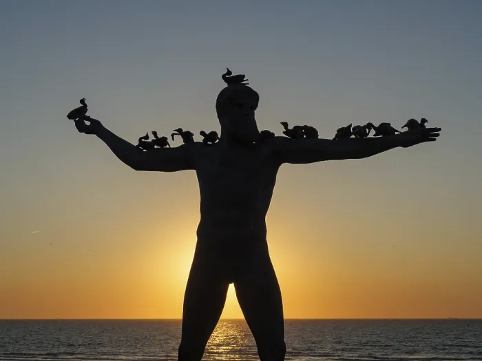 Framed Print : A statue with birds on its shoulders stands in the sunset Framed Print : A statue with birds on its shoulders stands in the sunset