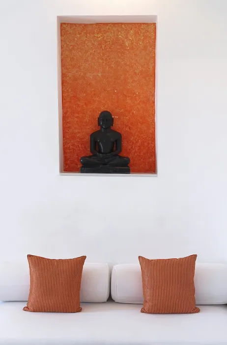 Framed Print : Statue of a black Buddha sitting meditating against an orange background Framed Print : Statue of a black Buddha sitting meditating against an orange background