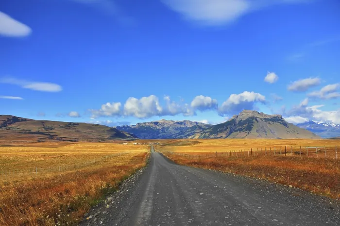 Framed Print : Steppes of Patagonia. Dirt road passes between the plains to the distant mountains
