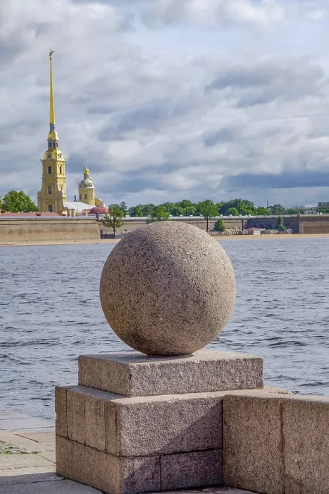 Framed Print : Stone ball on the river with cathedral in the background under a cloudy sky Framed Print : Stone ball on the river with cathedral in the background under a cloudy sky