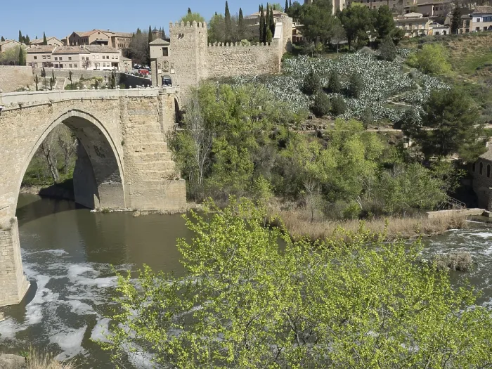 Framed Print : Stone bridge over a river surrounded by green trees and historic architecture under a blue sky Framed Print : Stone bridge over a river surrounded by green trees and historic architecture under a blue sky