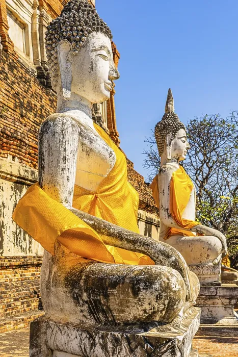 Framed Print : Stone Buddha statues decorated with yellow cloths