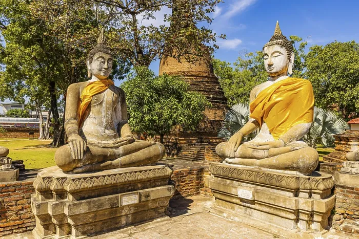 Framed Print : Stone Buddha statues decorated with yellow cloths