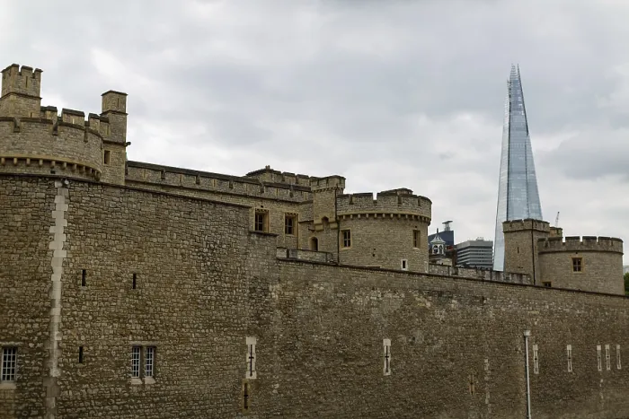 Framed Print : Stone fortress with modern skyscraper in background under cloudy sky at The Tower of London