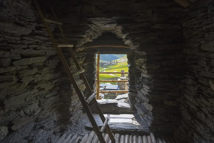 Framed Print : Stone interior of a defence tower with ladder and view of a green valley